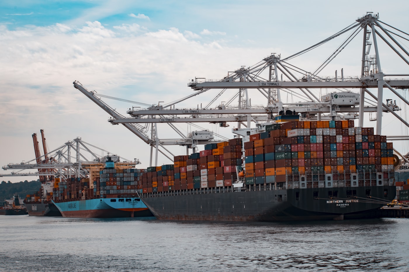 Container ship being loaded with cargo at a shipping port