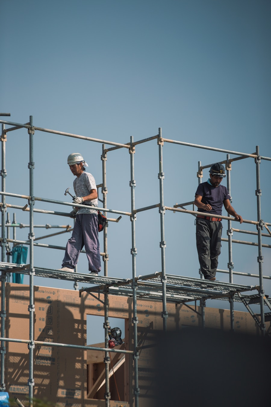 Construction workers on scaffolding building a structure